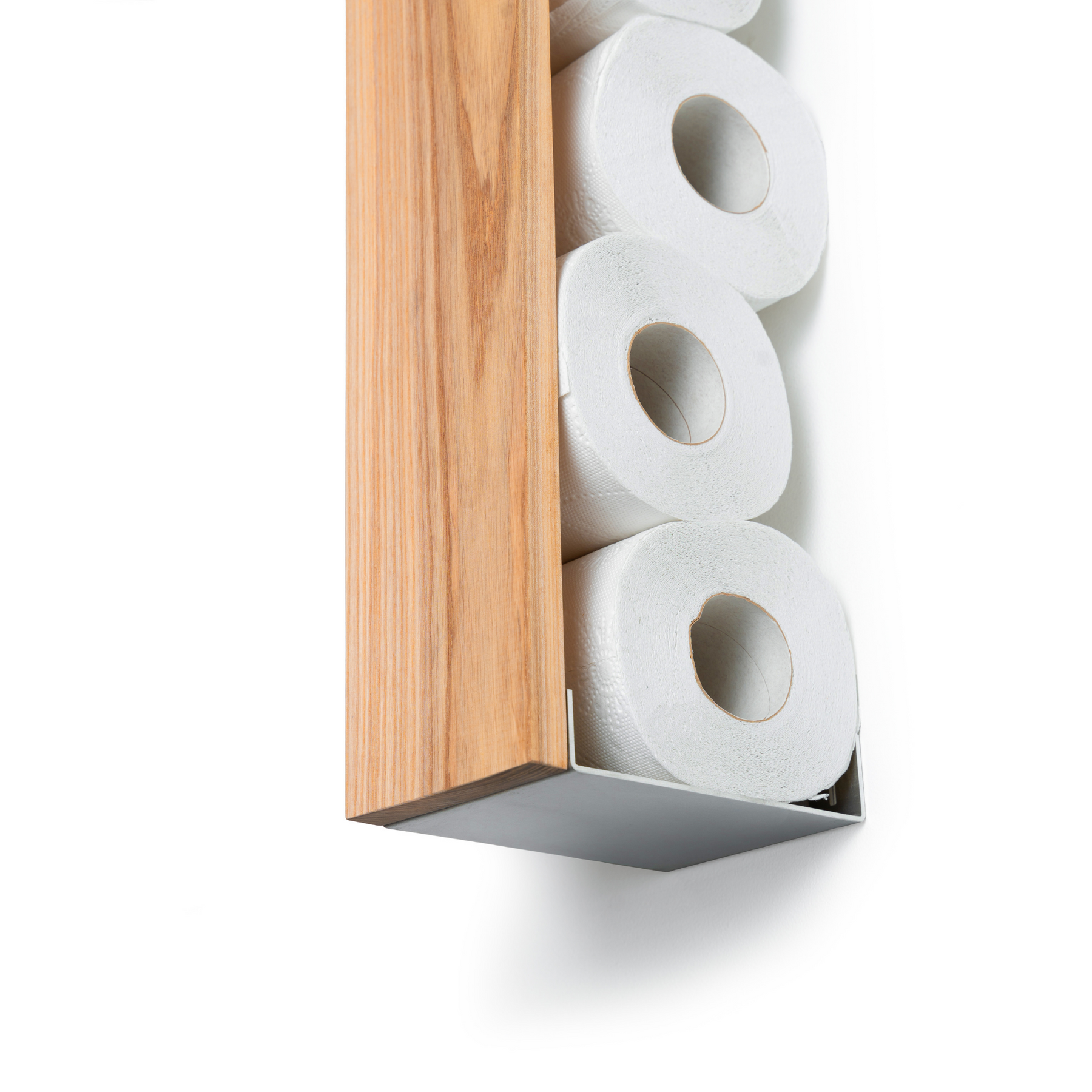 Vertical ashwood toilet paper holder with stainless steel base, holding multiple rolls of toilet paper, mounted on a wall