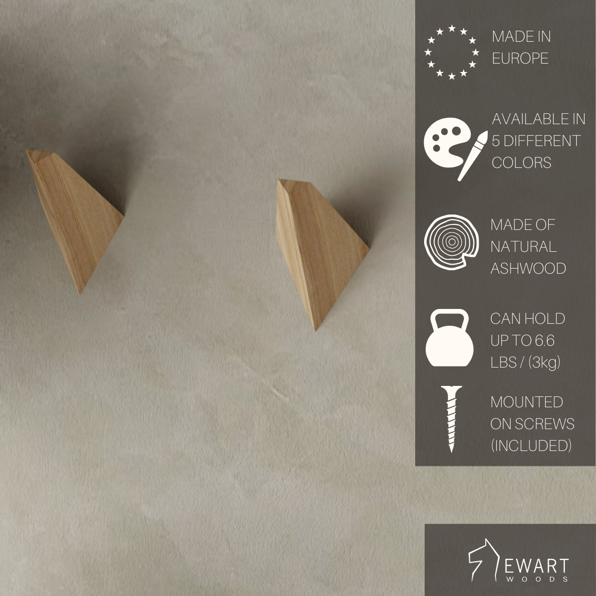 Triangular ashwood wall hooks on a neutral wall, labeled as European-made, available in 5 colors, holding up to 3 kg, with screws included. EWART WOODS logo displayed.