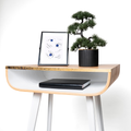 Close-up of wooden floating nightstand with brass design and white wooden legs