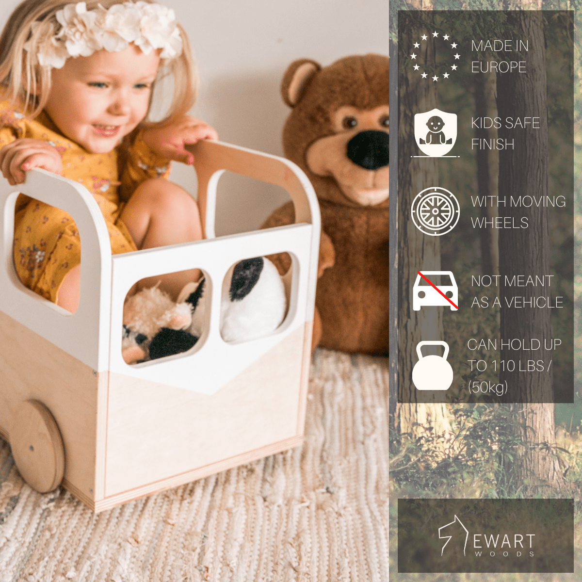 A young girl sitting inside a wooden toy bus with white accents and moving wheels, holding stuffed animals, with a teddy bear in the background on a cozy rug. The bus has a smooth, kid-safe finish and can hold up to 110 lbs.