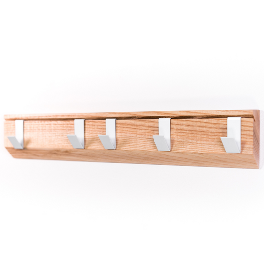 Clear view of wall mounted wood hanger with metal hooks