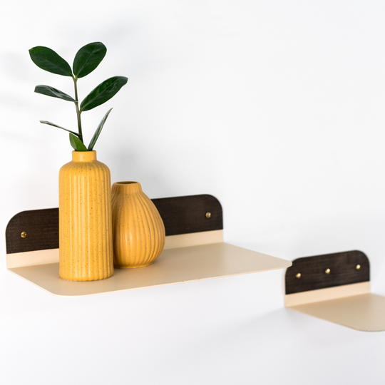 Minimalist wall shelf featuring a sleek, powder-coated metal surface with contrasting dark wood accents, ideal for modern decor.