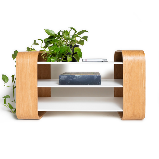 Front view of modern wooden coffee table with white shelves and brass accent on top