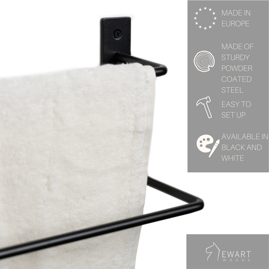 Black metal towel rack with a soft towel hanging, featuring product details: made in Europe, powder-coated steel, easy to set up, available in black and white, with Ewart Woods logo and slogan.