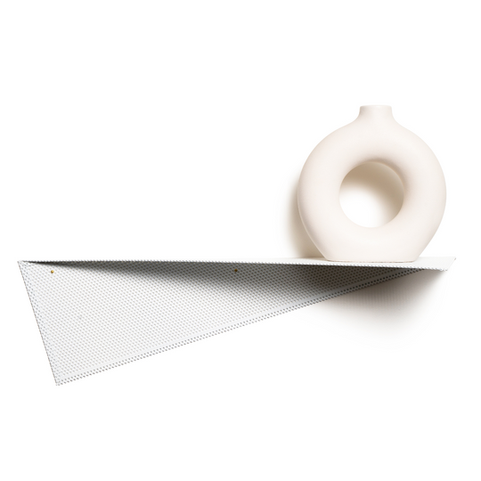 Perforated metal wall shelf with a unique triangular design, featuring a minimalist white ceramic vase as decor.