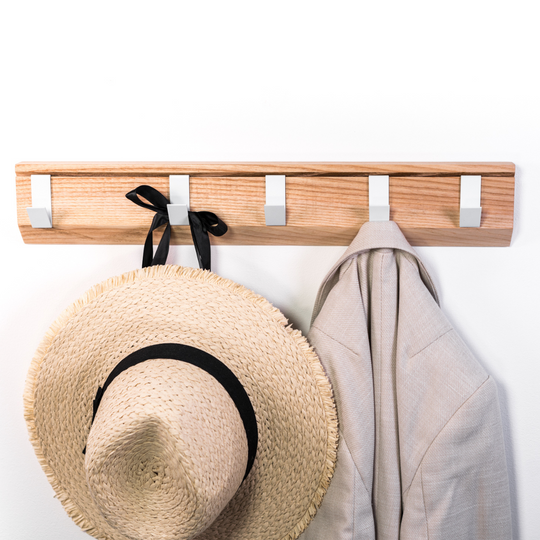 Front view of wall mounted wood hanger with metal hooks