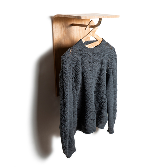 Front view of wood wall mounted minimalist hanger rack with brass accent