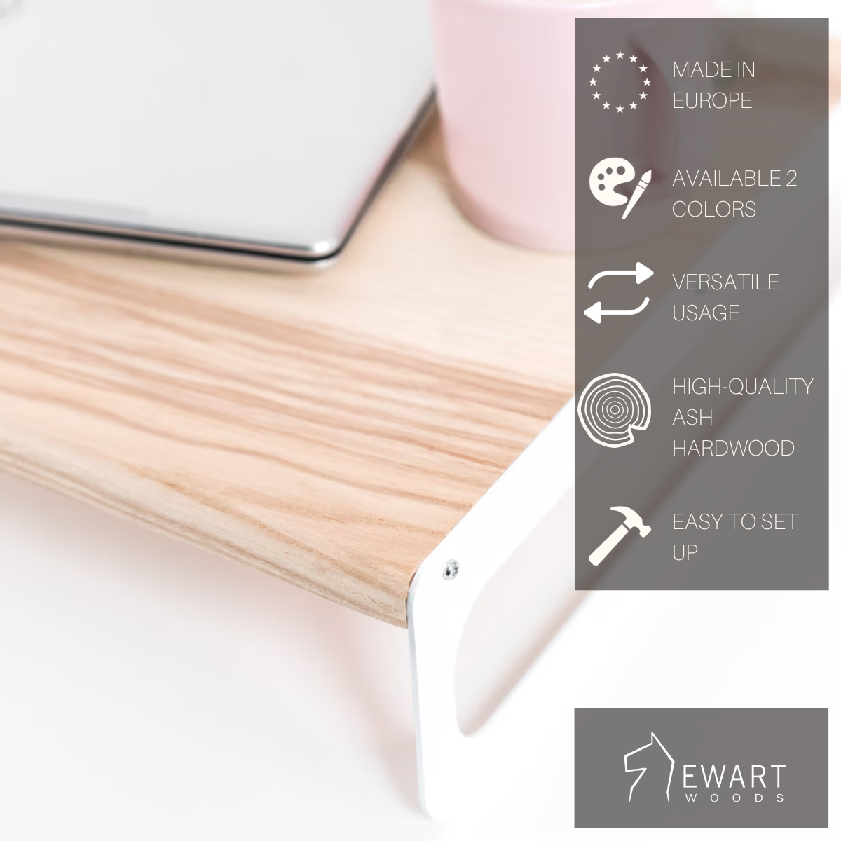 Wooden serving tray with a light ash finish and sleek white metal legs. The tray is shown with a laptop and features overlayed text highlighting key features: Made in Europe, available in 2 colors, versatile usage, high-quality ash hardwood, and easy to set up, with the 'EWART WOODS' logo.
