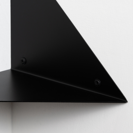 closeup of corner shelf wall mount screws visible white background