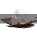 Curved wooden holder with rolled white towels and the Ewart Woods logo overlay with the tagline &