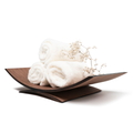 Curved wooden holder with rolled white towels and decorative white flowers, isolated on a white background.