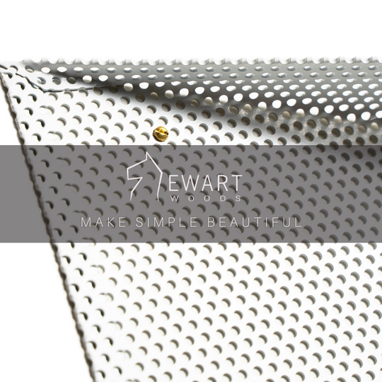 Close-up of a perforated wall shelf with a triangular design, featuring the EWART WOODS logo and the slogan &