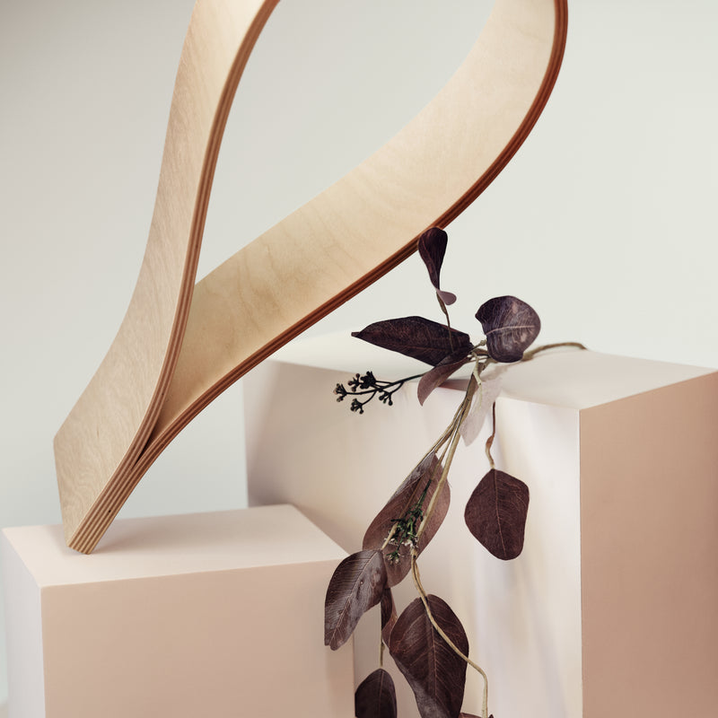 Close-up detail of drop shaped wooden toilet paper holder natural ash finish
