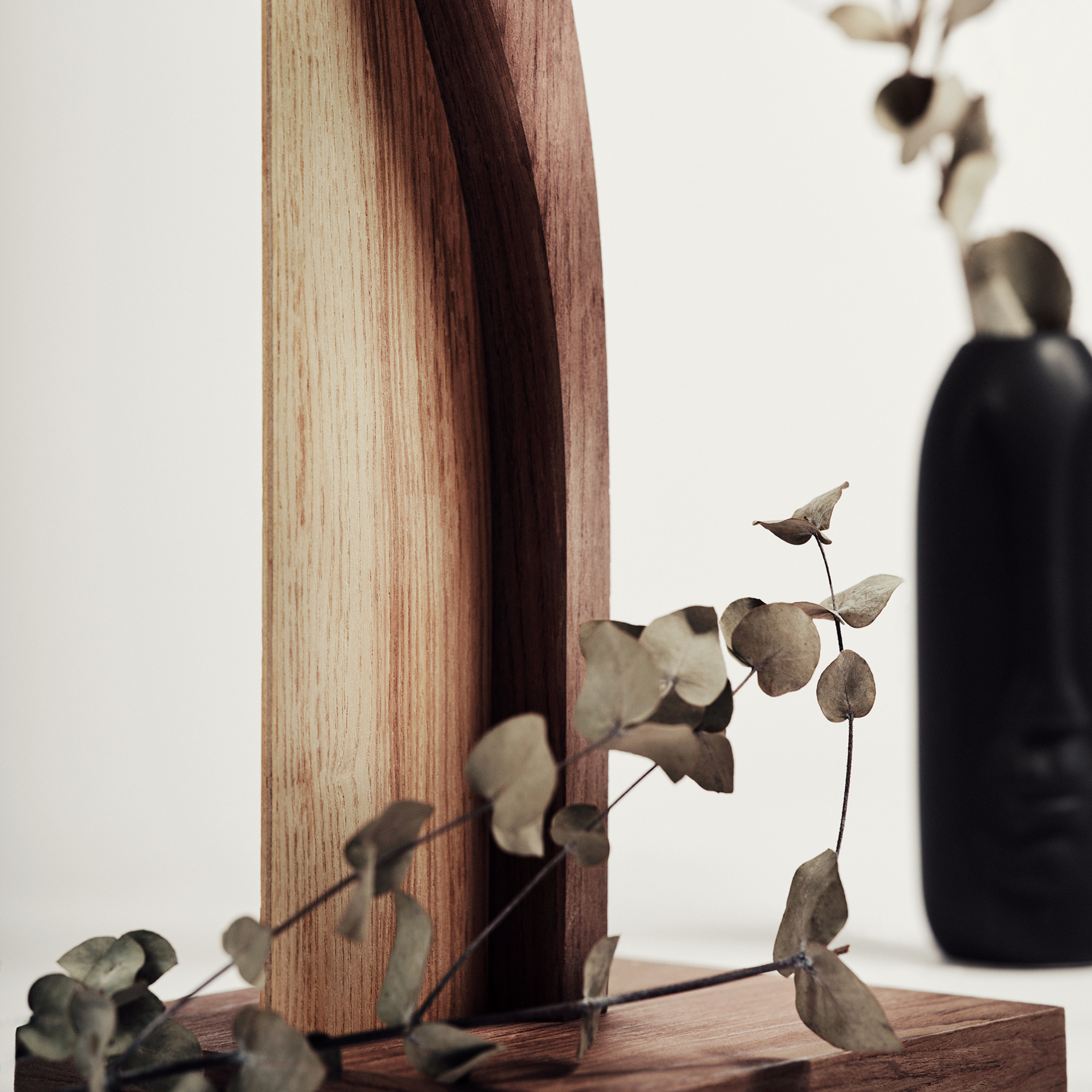 Close-up view of wooden standing toilet paper holder in ashwood with walnut color details