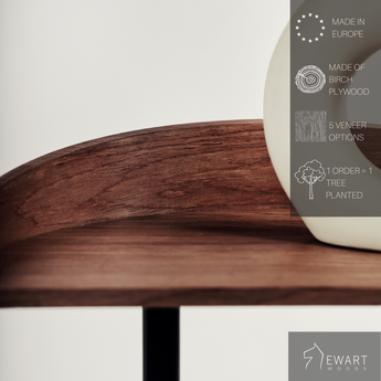 Close-up of a wooden surface of coffee and snack table for living room with white ceramic object on top made with manufacturer specifics