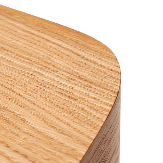 Close-up of curved edge for wooden nightstand with brass design