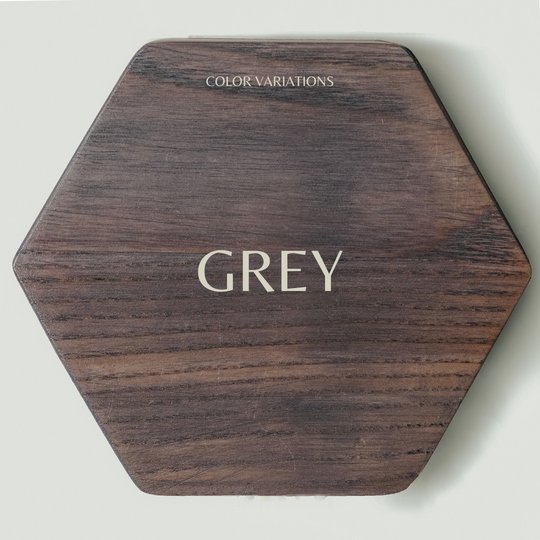 Hexagonal wooden key holder with a natural wood grain pattern, labeled &