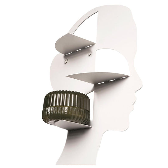 White metal wall shelf shaped like a face, featuring three shelves for displaying objects such as a glass jar.