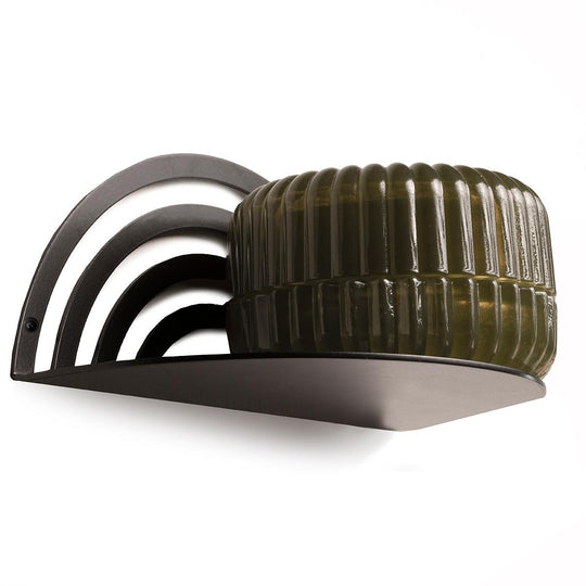 Curved black metal shelf with a layered backrest, secured with screws, holding a textured dark green container.