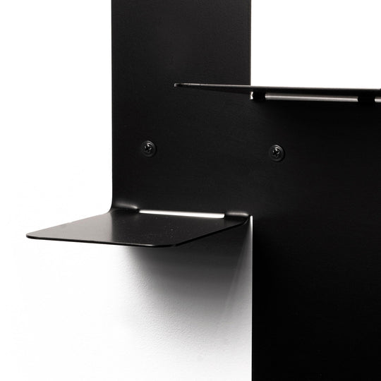 Close-up of a  contemporary black metal floating platform with visible hardware and dual-tiered surfaces.