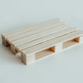 Handmade natural wooden pallet coaster with precise craftsmanship and smooth finish, displayed on a light background.