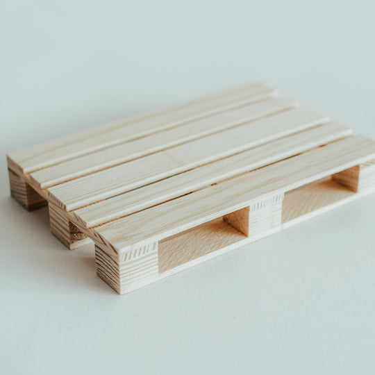 Handmade natural wooden pallet coaster with precise craftsmanship and smooth finish, displayed on a light background.