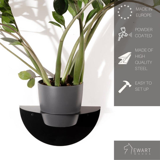 Sleek black wall-mounted planter with a powder-coated finish, holding a green plant in a grey pot. Made of high-quality steel and easy to set up.