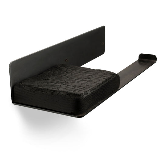 Close-up of a wall-mounted toilet paper holder with a matte black steel plate and a burned wood shelf, designed to hold a single roll of toilet paper.