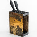 Rustic, industrial-style knife block with a weathered, patina-finished exterior and a wooden top, holding two black-handled knives. The block features a side slot for additional storage and is displayed against a white background.