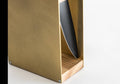 Close-up of a gold knife block with a natural wood base and a visible side slot holding a knife. The smooth wooden grain contrasts with the matte green metal, displayed against a white background.