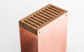 Rose gold knife block with a smooth metal exterior, wooden top. The block has a sleek, minimalist design and is displayed against a plain white background.