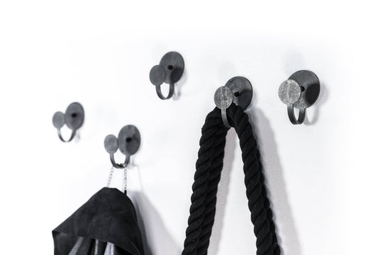Industrial-style black metal hooks with a matte finish and round backplates, perfect for hanging accessories like ropes and coats.