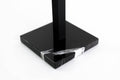 Close-up of a black marble base with striking white veining and a black metal stand, highlighting the luxurious design of the paper towel holder.