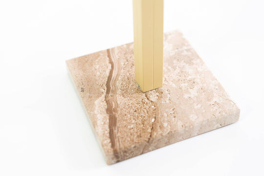 Close-up of a beige marble base with a gold metal stand, highlighting the natural stone pattern and sturdy construction of the paper towel holder.