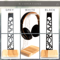 This image showcases three variations of the headphone stand, available in grey, white, and black, each featuring a different design cutout on the steel frame and a natural wood base.