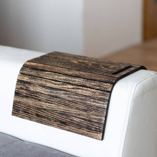 Burned Wooden Sofa Arm Tray Table on a couch arm, showcasing its versatility and stylish burnt wood finish. EWART WOODS