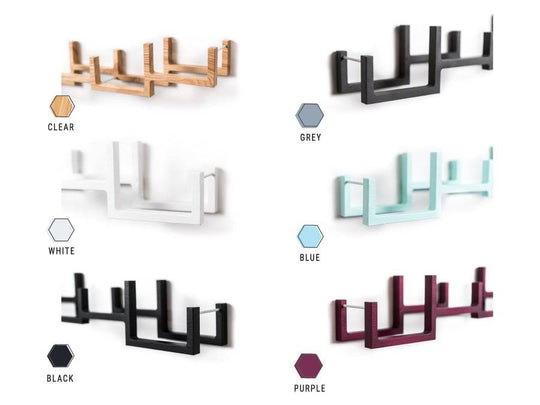A selection of wooden wall-mounted toilet paper holders in different colors: Clear, Grey, White, Blue, Black, and Purple.